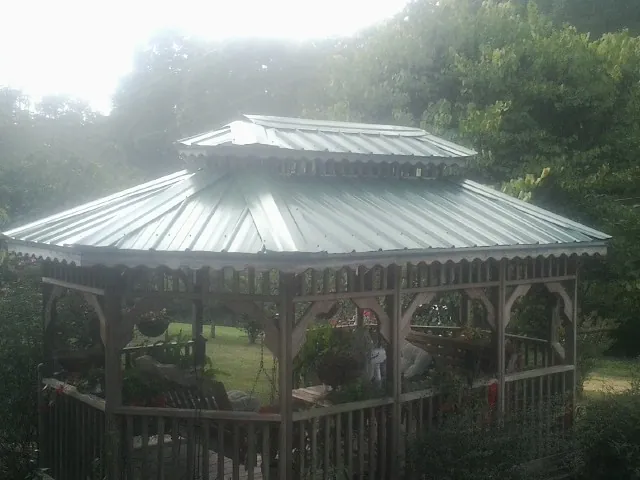 Two tier green metal roof on a garden gazebo in Millers Creek